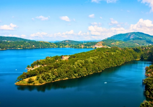 Blue lake surrounded by green hills in Meghalaya near Shillong